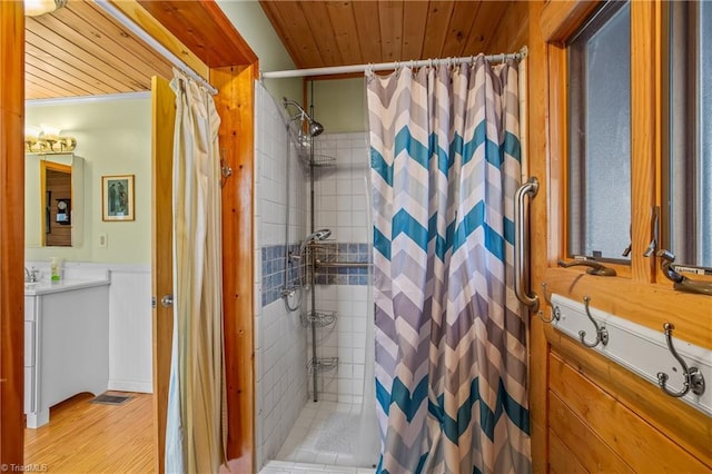 bathroom with hardwood / wood-style floors, curtained shower, vanity, crown molding, and wooden ceiling