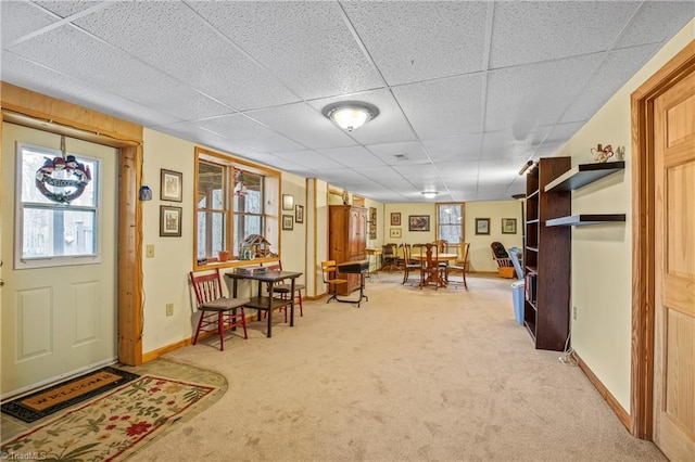 carpeted foyer entrance featuring a paneled ceiling