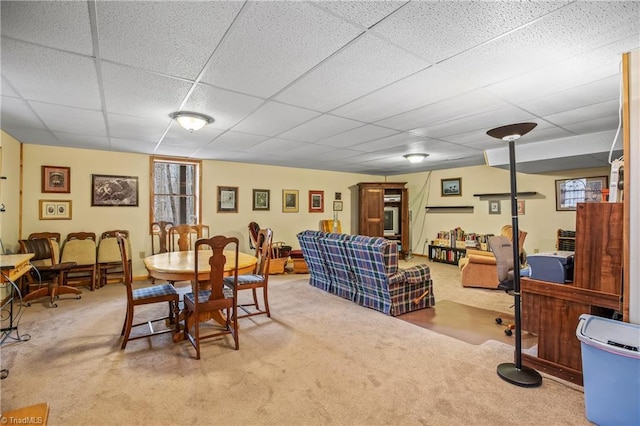 dining room featuring carpet floors and a drop ceiling