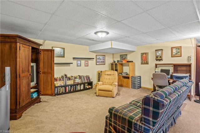 sitting room with light carpet and a paneled ceiling