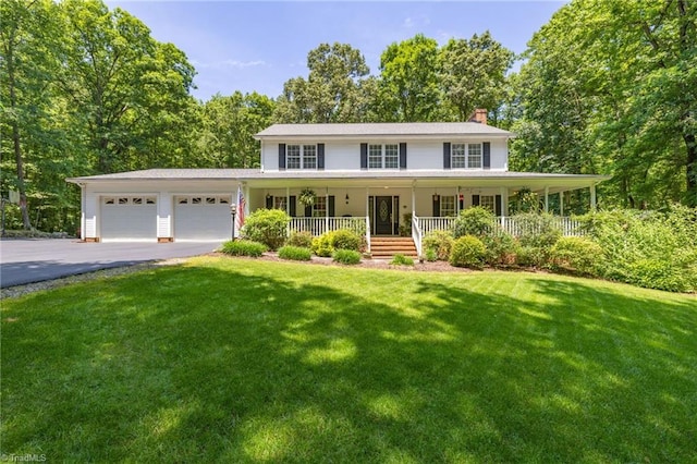 4717 Deaton Rd, Trinity, NC 27370 - view of front of property featuring a chimney, covered porch, a garage, asphalt driveway, and a front yard