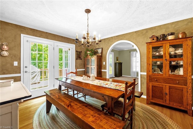 4717 Deaton Rd, Trinity, NC 27370 - dining area with light wood-style floors, healthy amount of natural light, a chandelier, arched walkways, and a textured ceiling