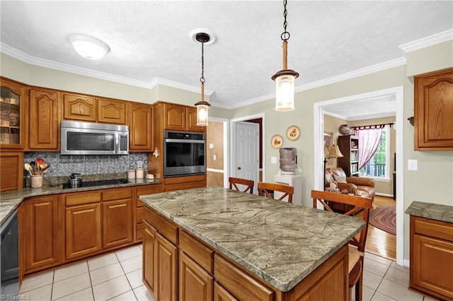 4717 Deaton Rd, Trinity, NC 27370 - kitchen featuring black appliances, brown cabinets, backsplash, light tile patterned floors, and a kitchen island