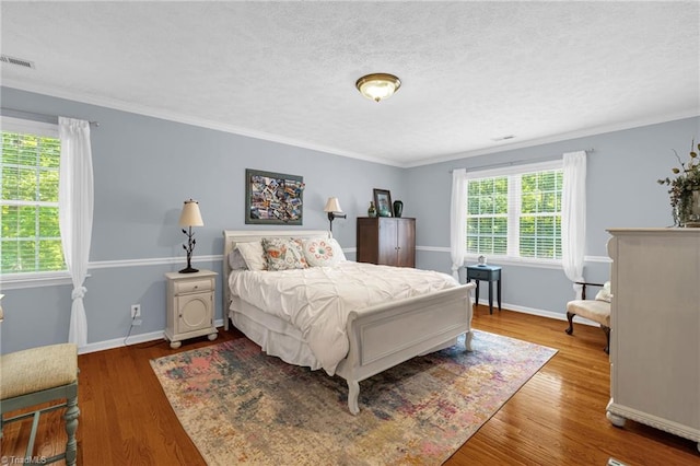 4717 Deaton Rd, Trinity, NC 27370 - bedroom featuring wood finished floors, crown molding, and a textured ceiling