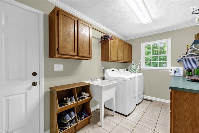 4717 Deaton Rd, Trinity, NC 27370 - laundry room featuring cabinet space, separate washer and dryer, a textured ceiling, light tile patterned flooring, and ornamental molding