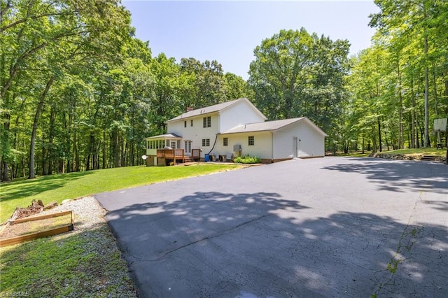 4717 Deaton Rd, Trinity, NC 27370 - view of front facade featuring a wooden deck, a front lawn, a view of trees, a chimney, and driveway
