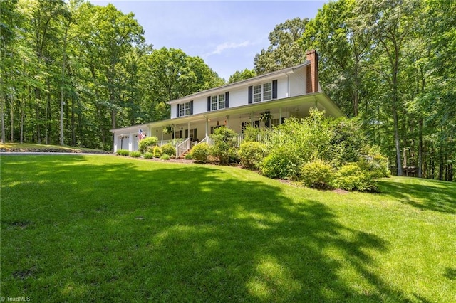 4717 Deaton Rd, Trinity, NC 27370 - view of front of home featuring a garage, a chimney, a front yard, and a porch