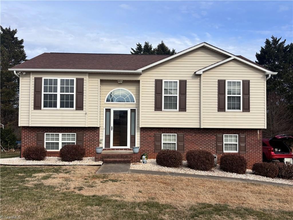 bi-level home with a front yard