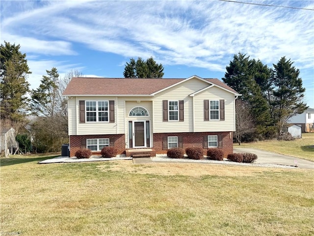 bi-level home with a front yard and cooling unit