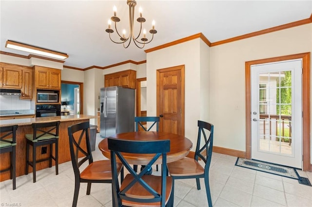 dining room featuring a chandelier, crown molding, and baseboards