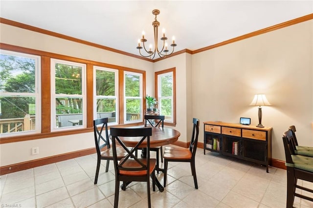 dining room featuring baseboards, a chandelier, and crown molding