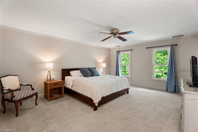 bedroom featuring crown molding, light colored carpet, baseboards, and ceiling fan