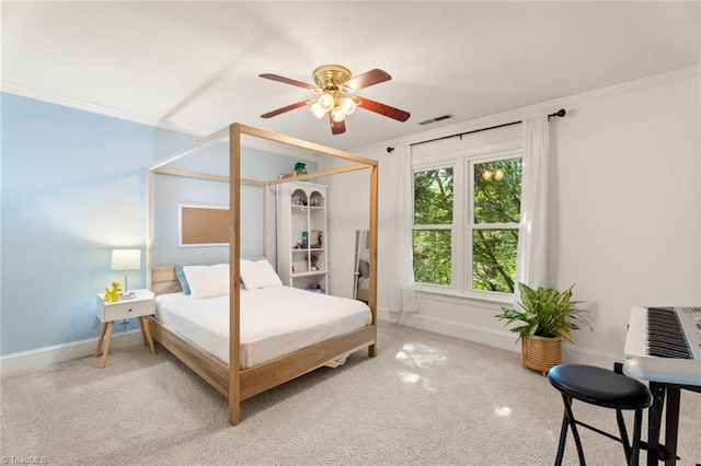 bedroom with light colored carpet, crown molding, baseboards, and a ceiling fan