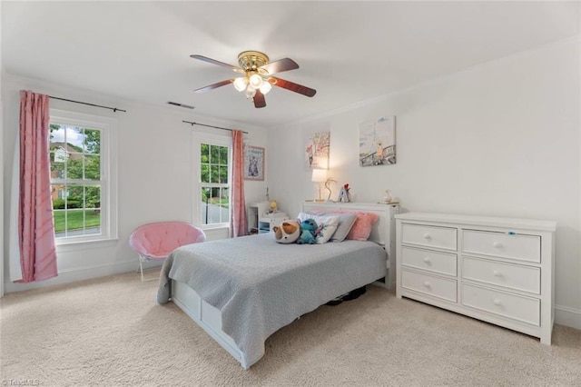 carpeted bedroom with baseboards and a ceiling fan