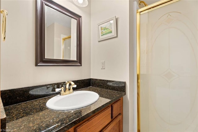 bathroom with a shower stall and vanity