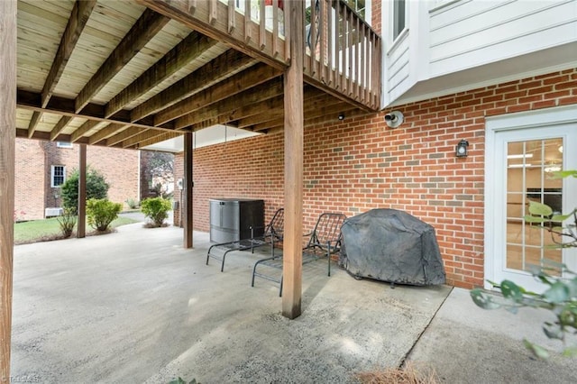 view of patio with central air condition unit and a grill