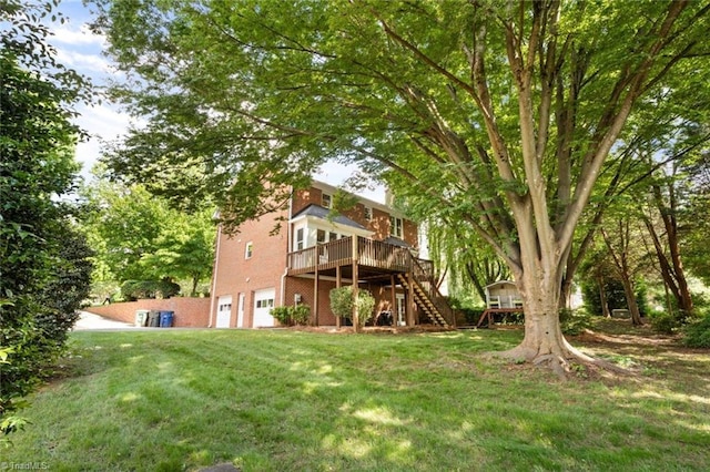 rear view of house with stairway, a wooden deck, a garage, a lawn, and brick siding