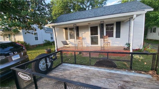 312 Bridge St, Eden, NC 27288 - view of front of house featuring a porch, a fenced front yard, and a shingled roof