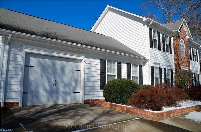 view of side of home featuring a garage