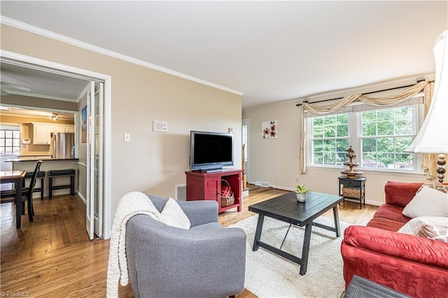 2014 Medhurst Dr, Greensboro, NC 27410 - living room with crown molding, light wood finished floors, plenty of natural light, and baseboards