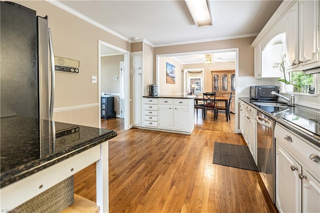 2014 Medhurst Dr, Greensboro, NC 27410 - kitchen with stainless steel appliances, white cabinetry, light wood-style floors, crown molding, and a sink