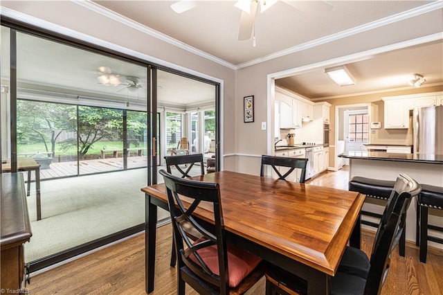 2014 Medhurst Dr, Greensboro, NC 27410 - dining space featuring a ceiling fan, light wood-type flooring, healthy amount of natural light, and crown molding