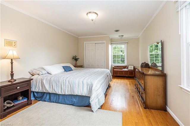 2014 Medhurst Dr, Greensboro, NC 27410 - bedroom featuring light wood-style floors, a closet, ornamental molding, and baseboards