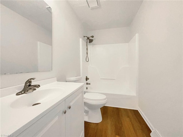 full bathroom with toilet, wood finished floors, vanity, bathing tub / shower combination, and baseboards