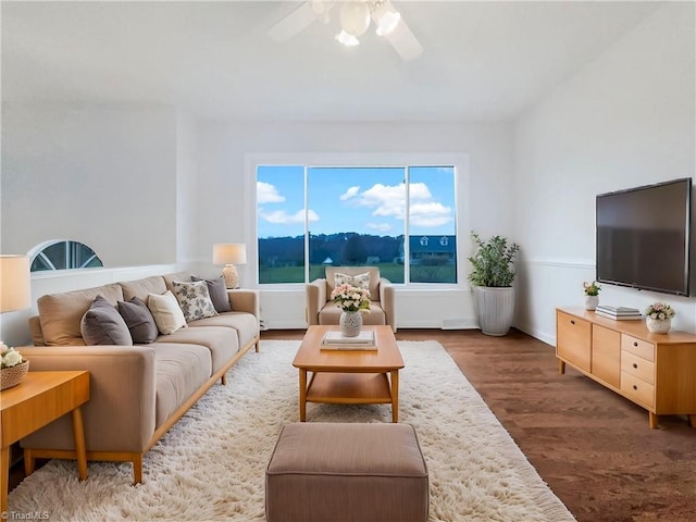 living area with wood finished floors and a ceiling fan