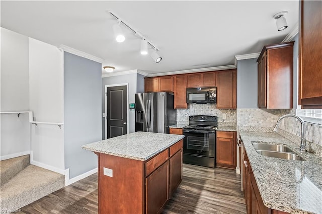 kitchen with decorative backsplash, black appliances, dark wood-style floors, and a sink