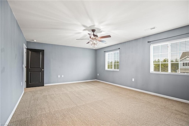 unfurnished room with visible vents, baseboards, ceiling fan, and carpet flooring