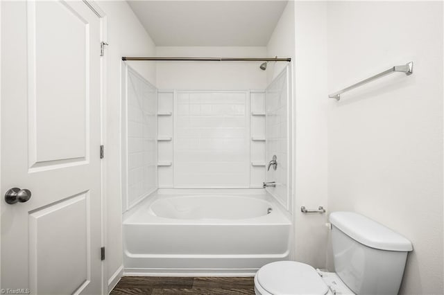 full bathroom with tub / shower combination, toilet, and wood finished floors