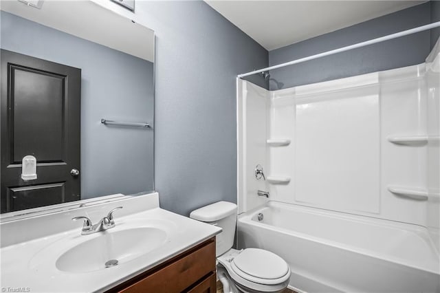 full bath with toilet, bathtub / shower combination, vanity, and a textured wall