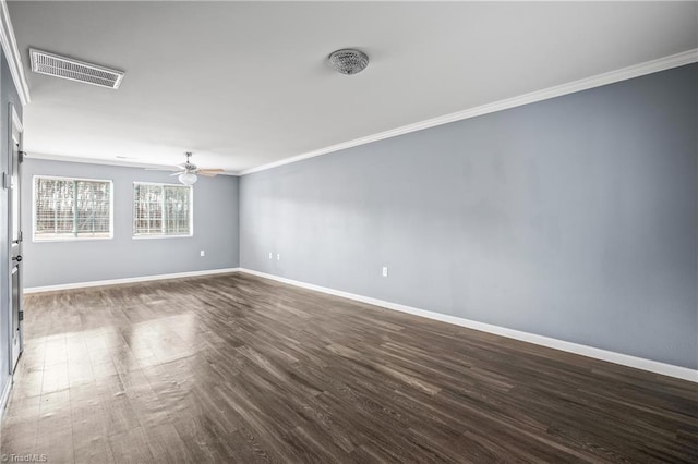 spare room with visible vents, dark wood-style floors, crown molding, baseboards, and ceiling fan