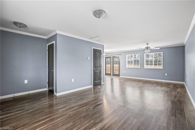 empty room with dark wood-style floors, a ceiling fan, crown molding, and baseboards