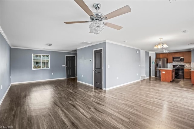 unfurnished living room with visible vents, wood finished floors, baseboards, and ornamental molding