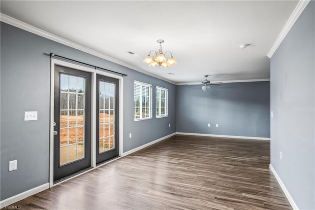 empty room with crown molding, baseboards, and wood finished floors