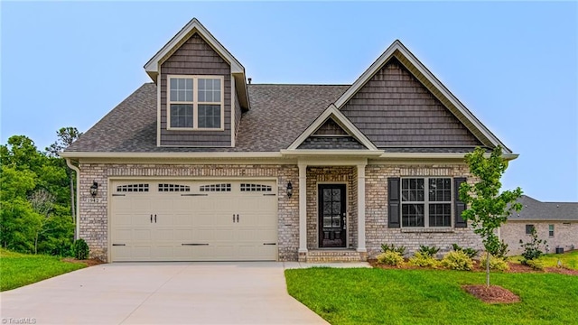 view of front of house featuring a garage and a front yard