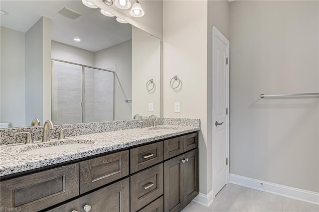 bathroom featuring vanity and a shower with shower door