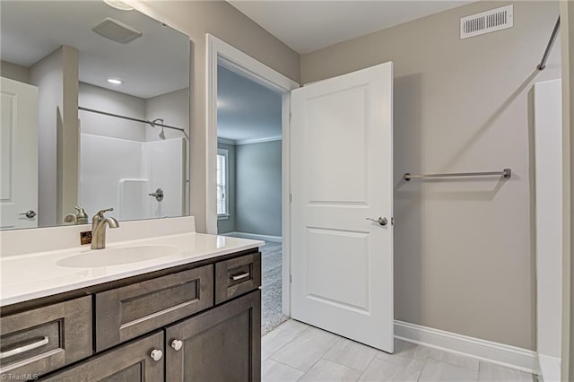 bathroom featuring a shower, tile patterned flooring, and vanity