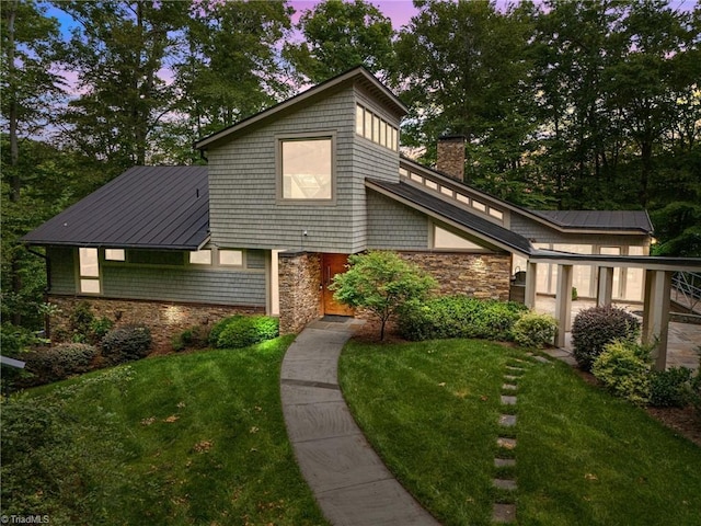 343 Lakewood Pointe Dr, Roxboro, NC 27574 - mid-century modern home featuring stone siding, a front lawn, and a chimney