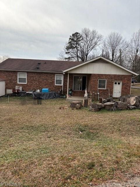 rear view of house with a yard