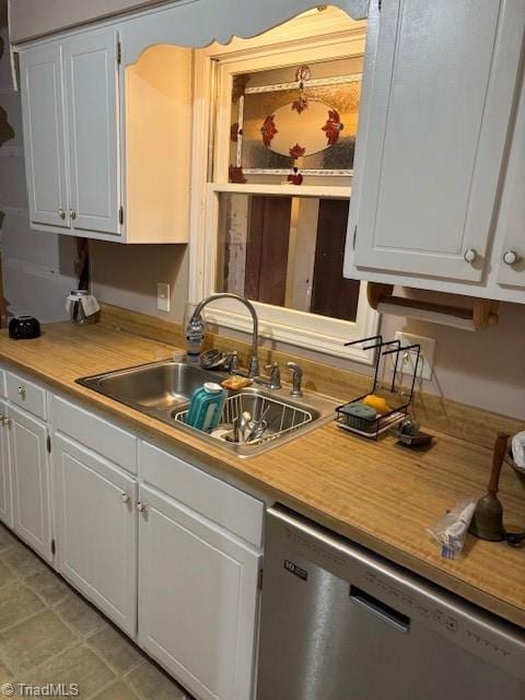 kitchen with white cabinetry, sink, and dishwasher