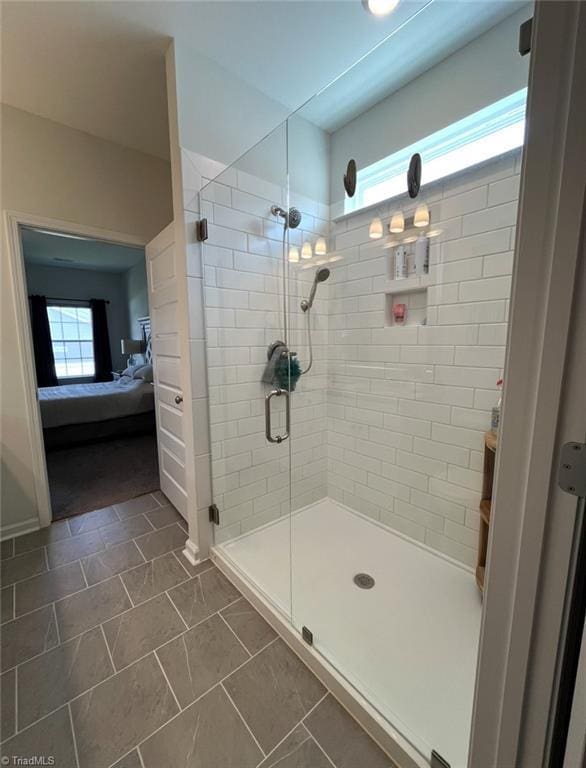 ensuite bathroom with tile patterned flooring, a shower stall, and connected bathroom