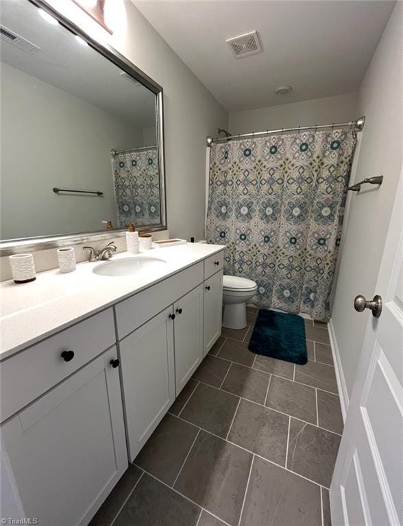 bathroom with visible vents, tile patterned flooring, toilet, and vanity