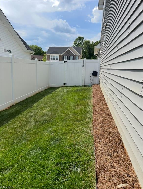 view of yard with a gate and a fenced backyard