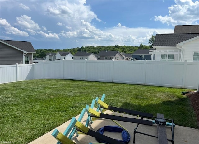 view of yard featuring a residential view and a fenced backyard