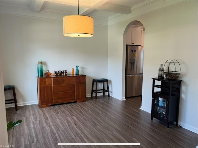 interior space with baseboards, arched walkways, dark wood-style flooring, and beam ceiling