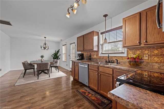 1310 Silver Dr, Mebane, NC 27302 - kitchen with stainless steel dishwasher, a sink, and brown cabinets
