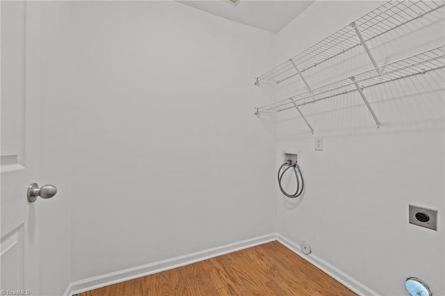 1310 Silver Dr, Mebane, NC 27302 - laundry area with washer hookup, hookup for an electric dryer, baseboards, light wood-style flooring, and hookup for a gas dryer